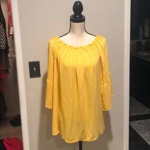 Yellow off the shoulder blouse.